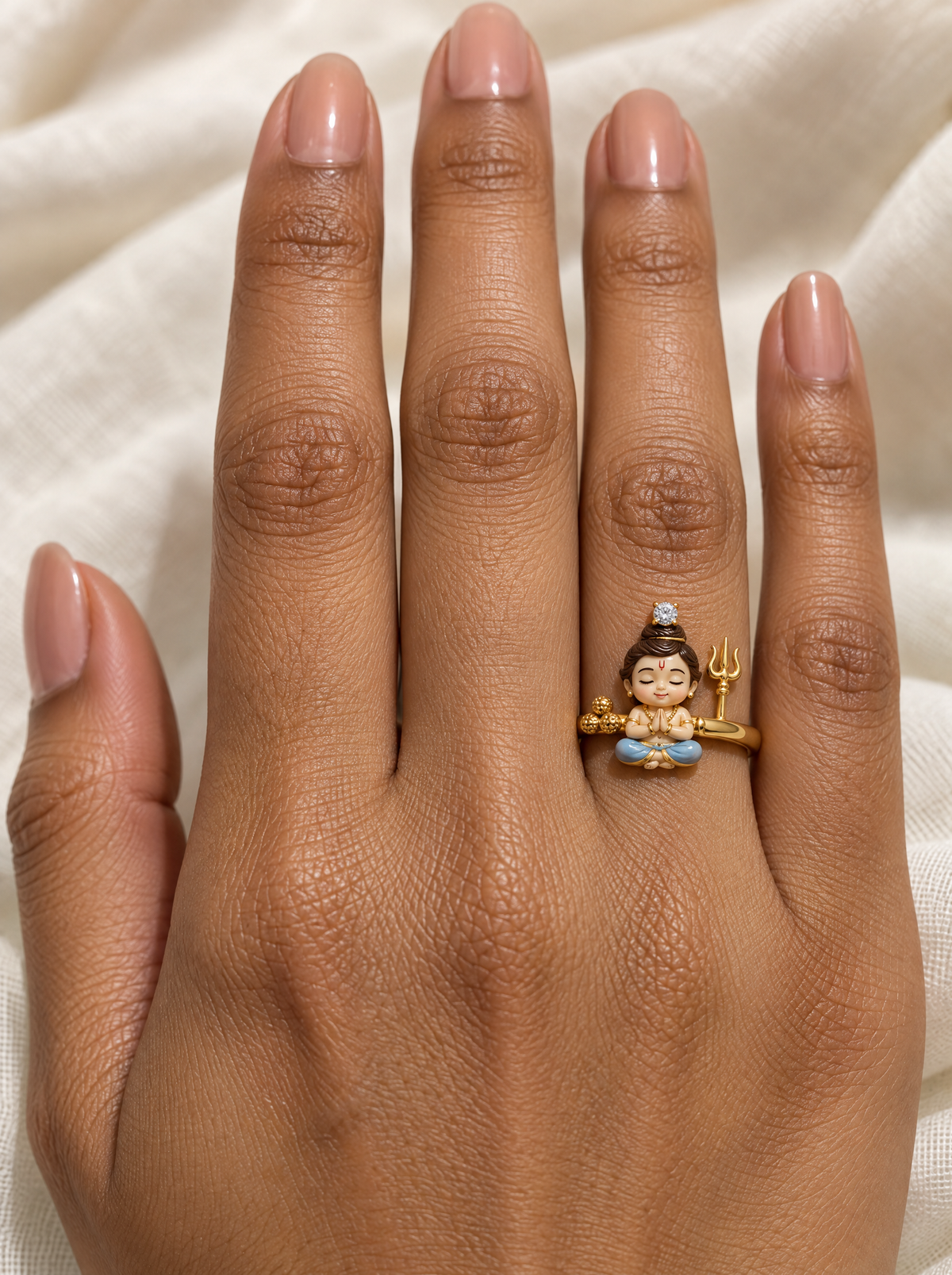 Bal Shiva Rudraksha ring – fair baby Shiva in powder-blue dhoti with gold rudraksha beads, trishul and a lab grown diamond on his jata, worn on the ring finger