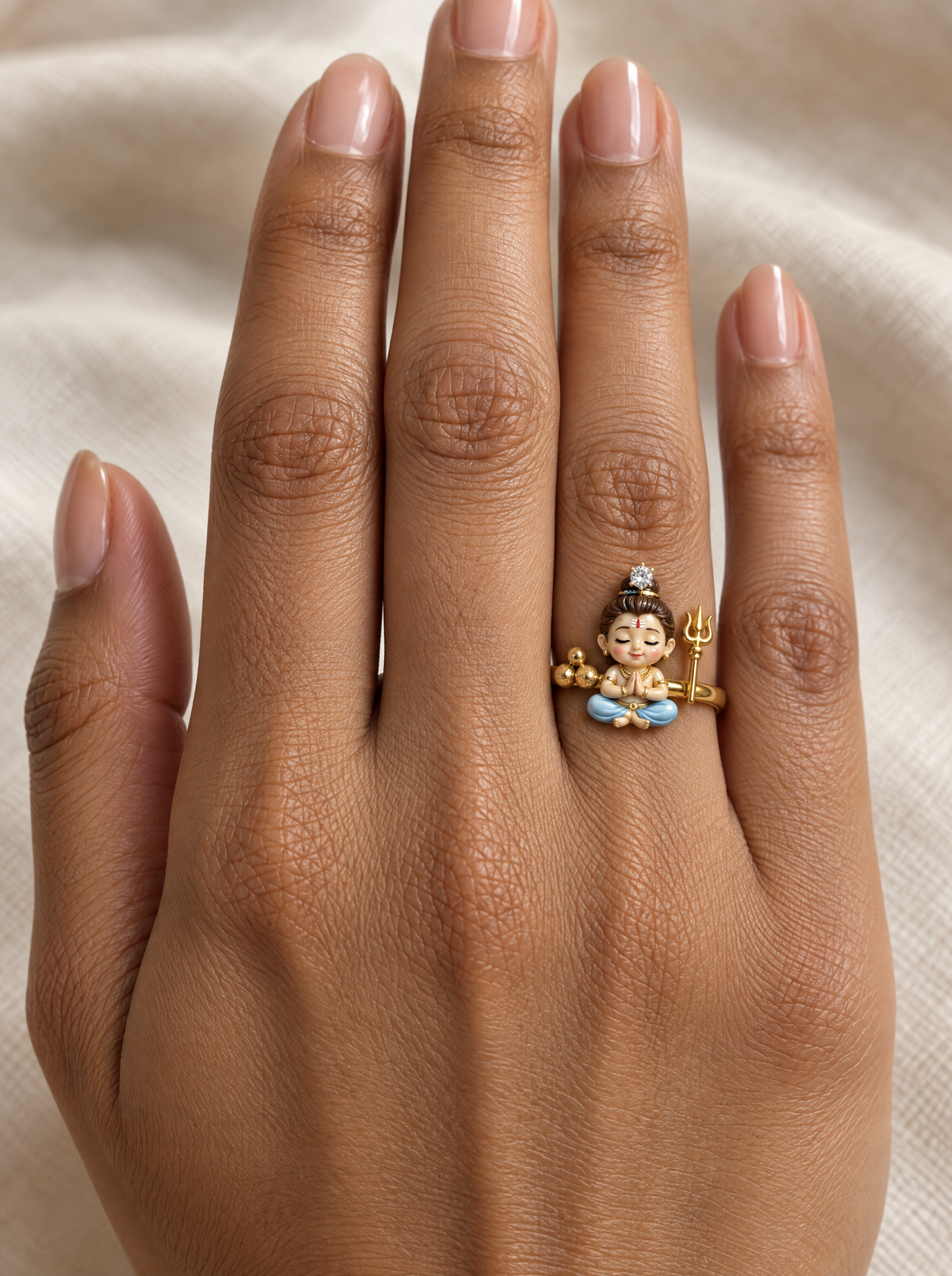 Bal Shiva Mahayogi ring – baby Shiva in lotus pose with gold rudraksha beads, trishul and a lab grown diamond on his jata, worn on the ring finger