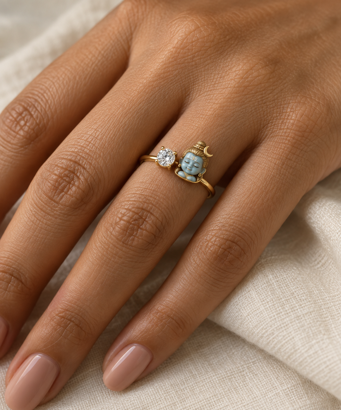 Bal Shiva Namaste ring – sky-blue enamel baby Shiva with folded hands beside a lab grown diamond solitaire, worn on the ring finger