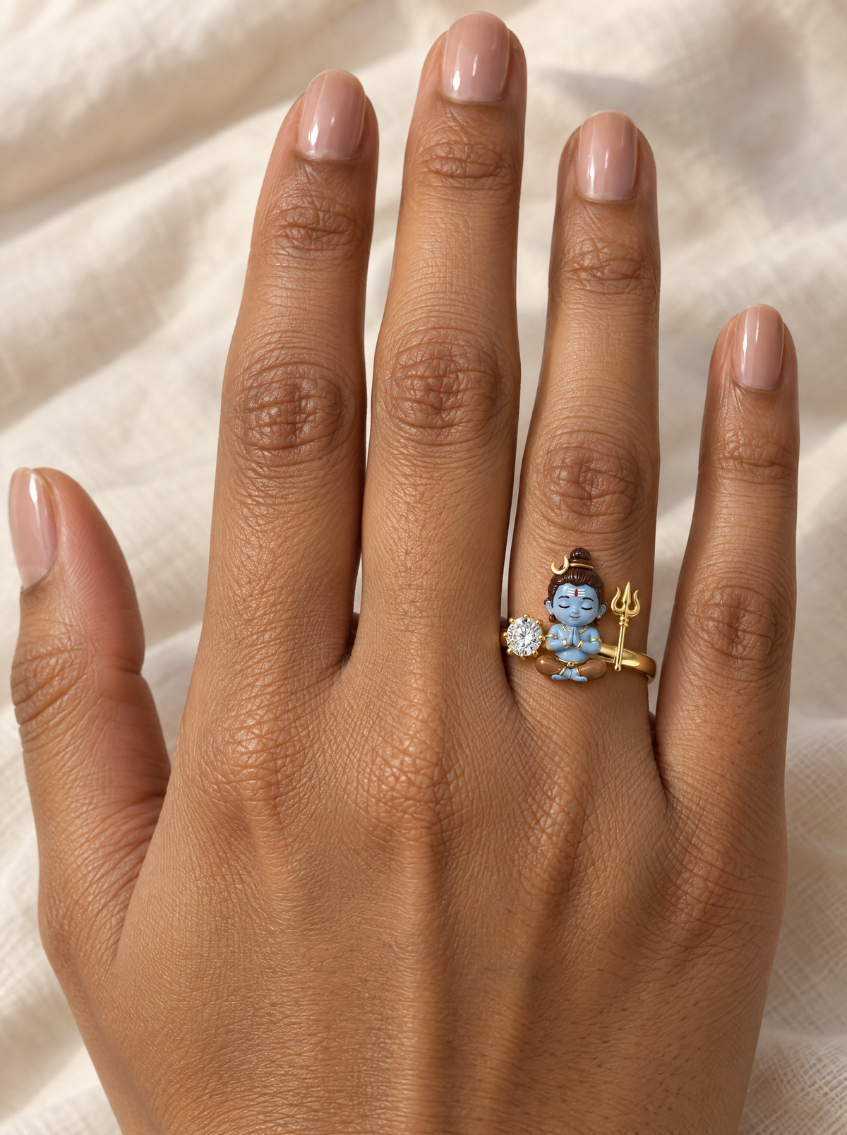 Bal Shiva Shambhu ring – seated between a lab grown diamond solitaire and a gold trishul, crescent moon in his jata, worn on the ring finger