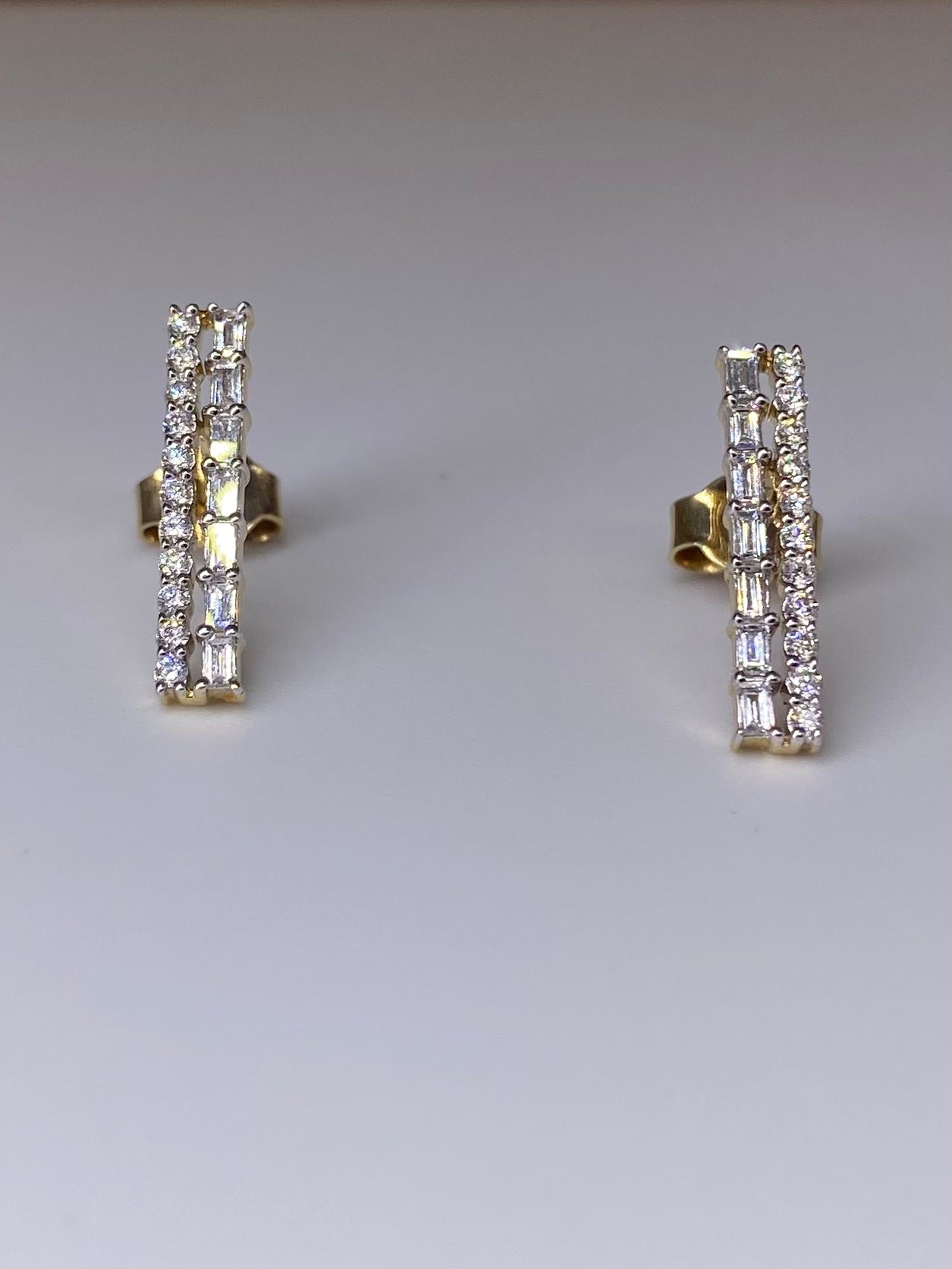 Close-up of Chic Aurora Baguette Lab Diamond Earrings in 14K Yellow Gold by Fiona Diamonds