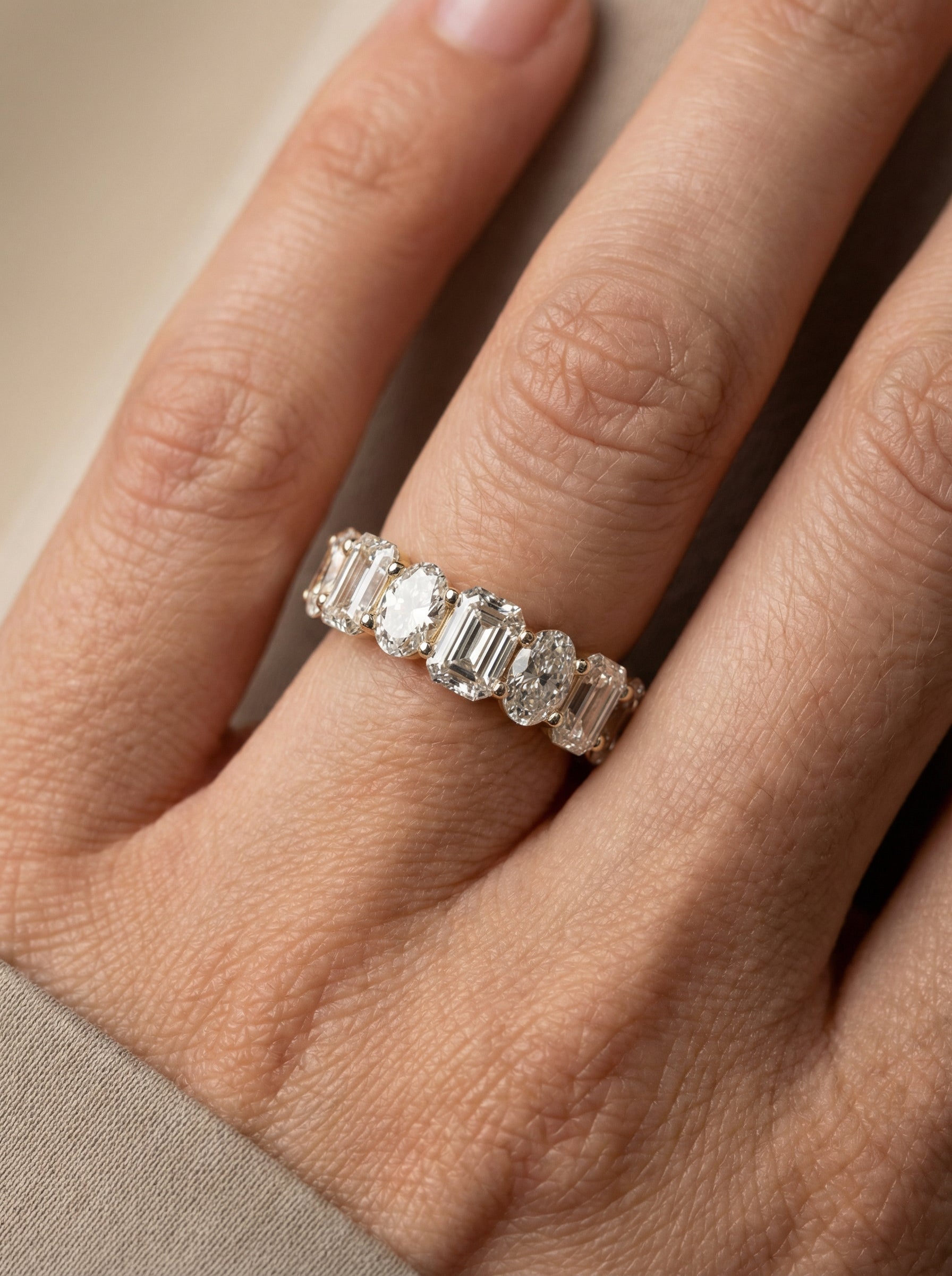 Close-up of Calora Zenith Oval Lab Diamond Eternity Ring set in 18K Yellow Gold by Fiona Diamonds