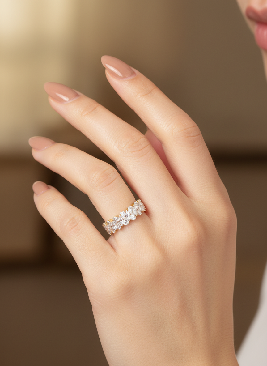 Close-up of Avyxor Curve Pear Lab Diamond Eternity Ring set in 18K Yellow Gold by Fiona Diamonds