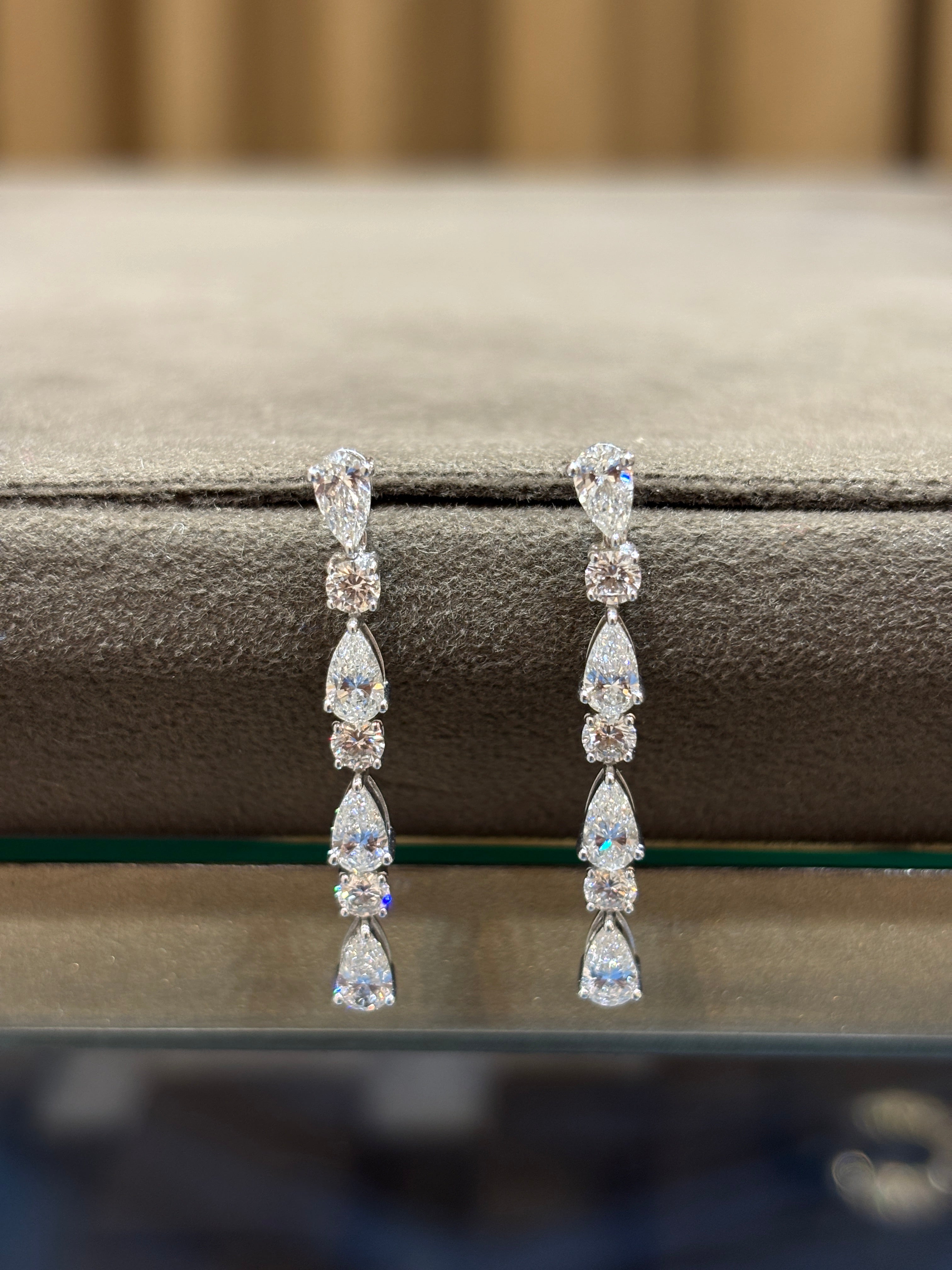 Close-up of Divine Cascade Pear Lab Diamond Dangler Earrings in 18K White Gold by Fiona Diamonds