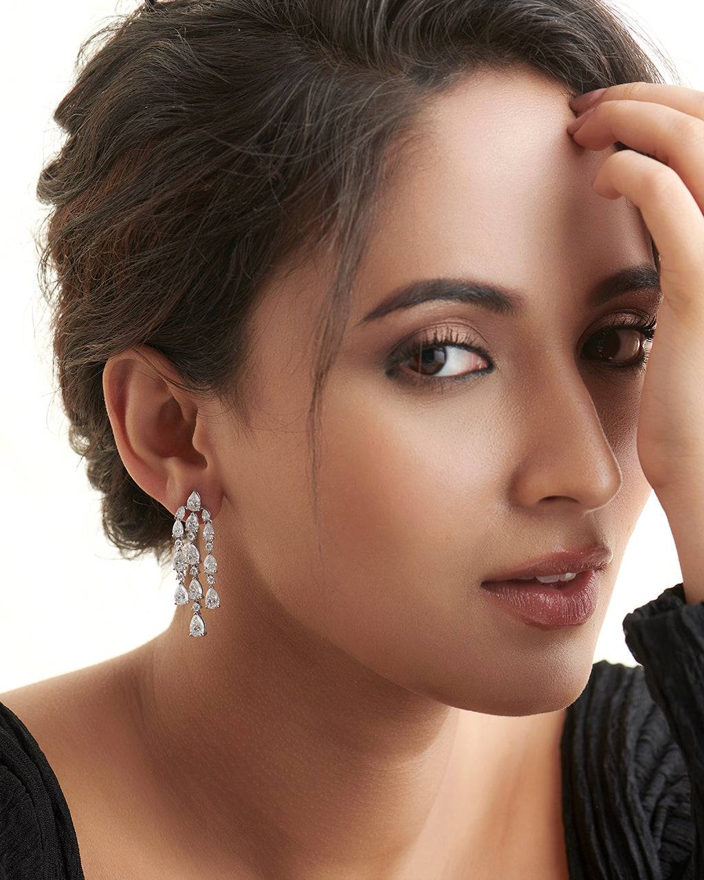 Close-up of Una Pear Lab Diamond Dangler Earrings in 18K White Gold by Fiona Diamonds