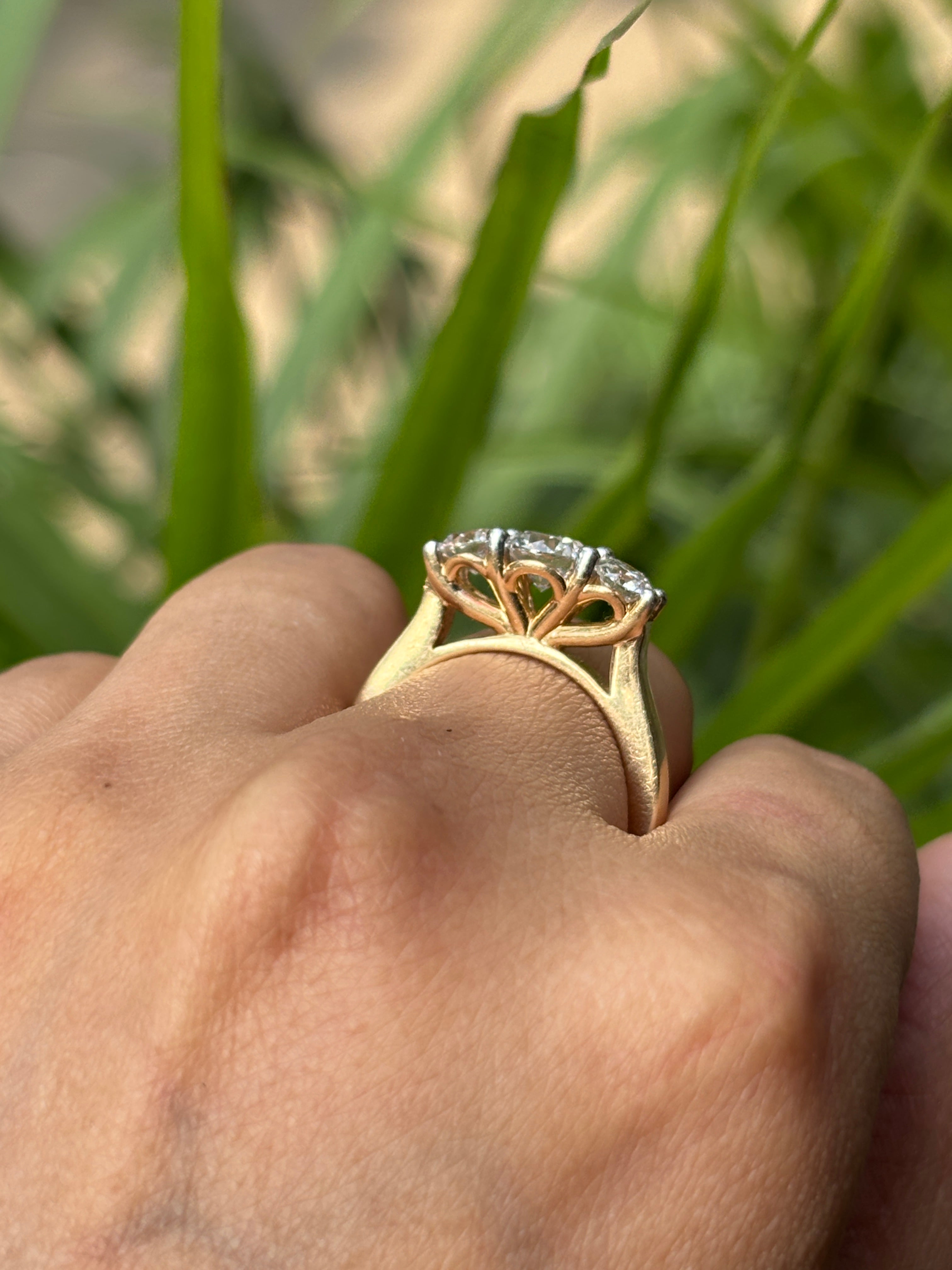 Close-up of 1.28ct Round Three Stone Round Lab Diamond Three Stone Ring set in 14K Yellow Gold by Fiona Diamonds