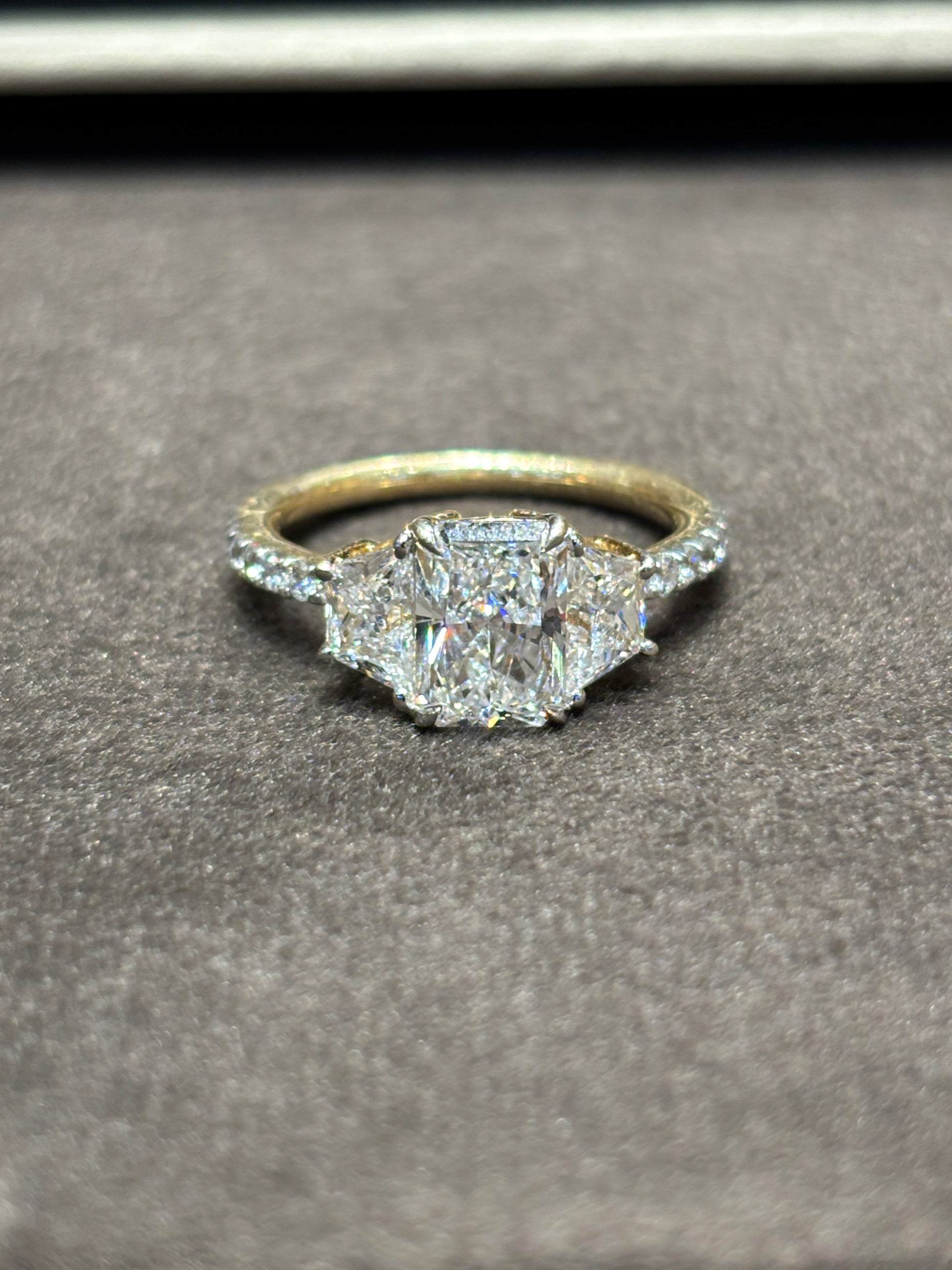 Close-up of Jovielle 1.5ct Radiant Lab Diamond Three Stone Ring set in 14K Yellow Gold by Fiona Diamonds