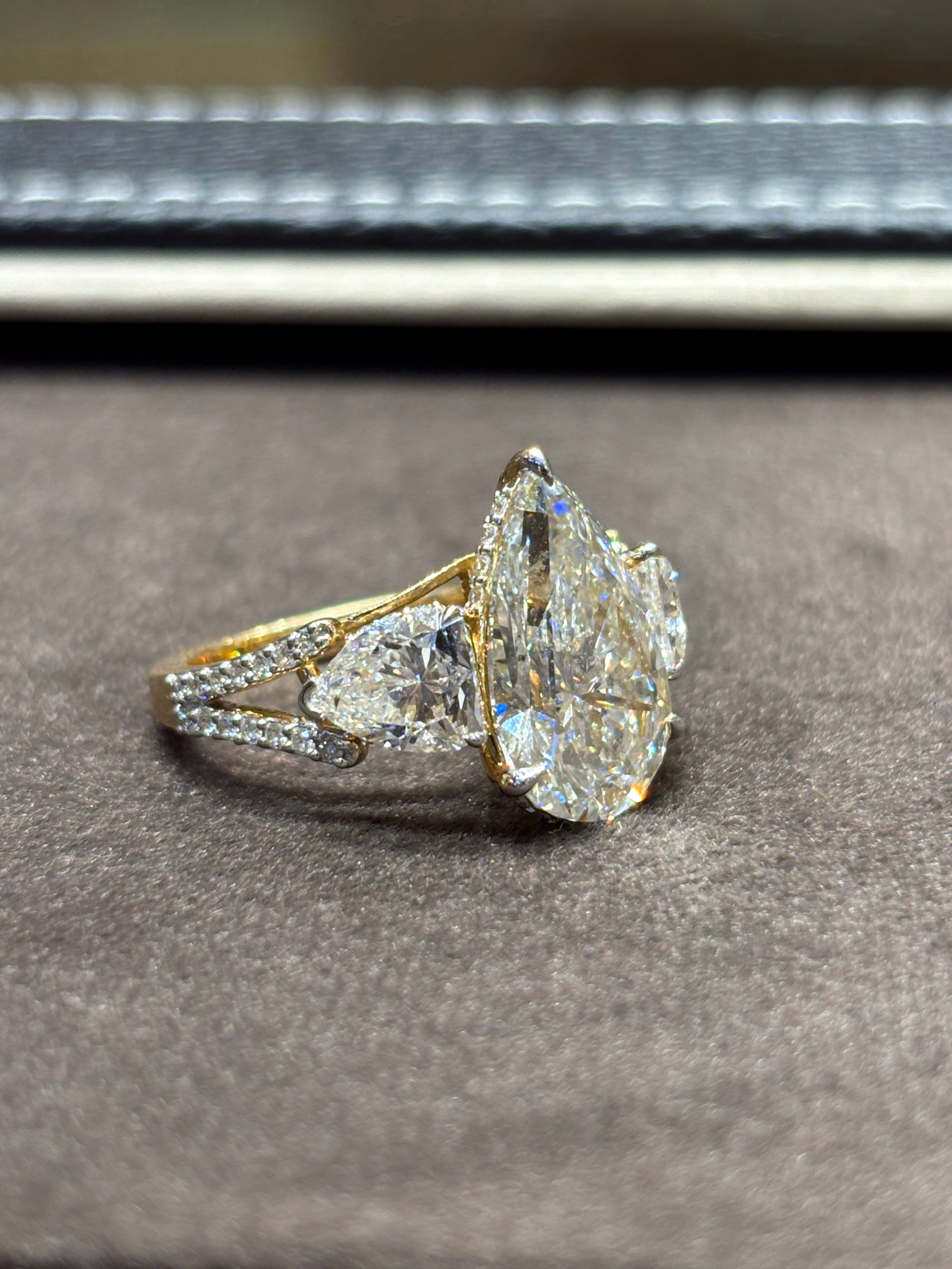 Close-up of Eloura Bliss 5ct Pear Lab Diamond Three Stone Ring set in 18K Yellow Gold by Fiona Diamonds