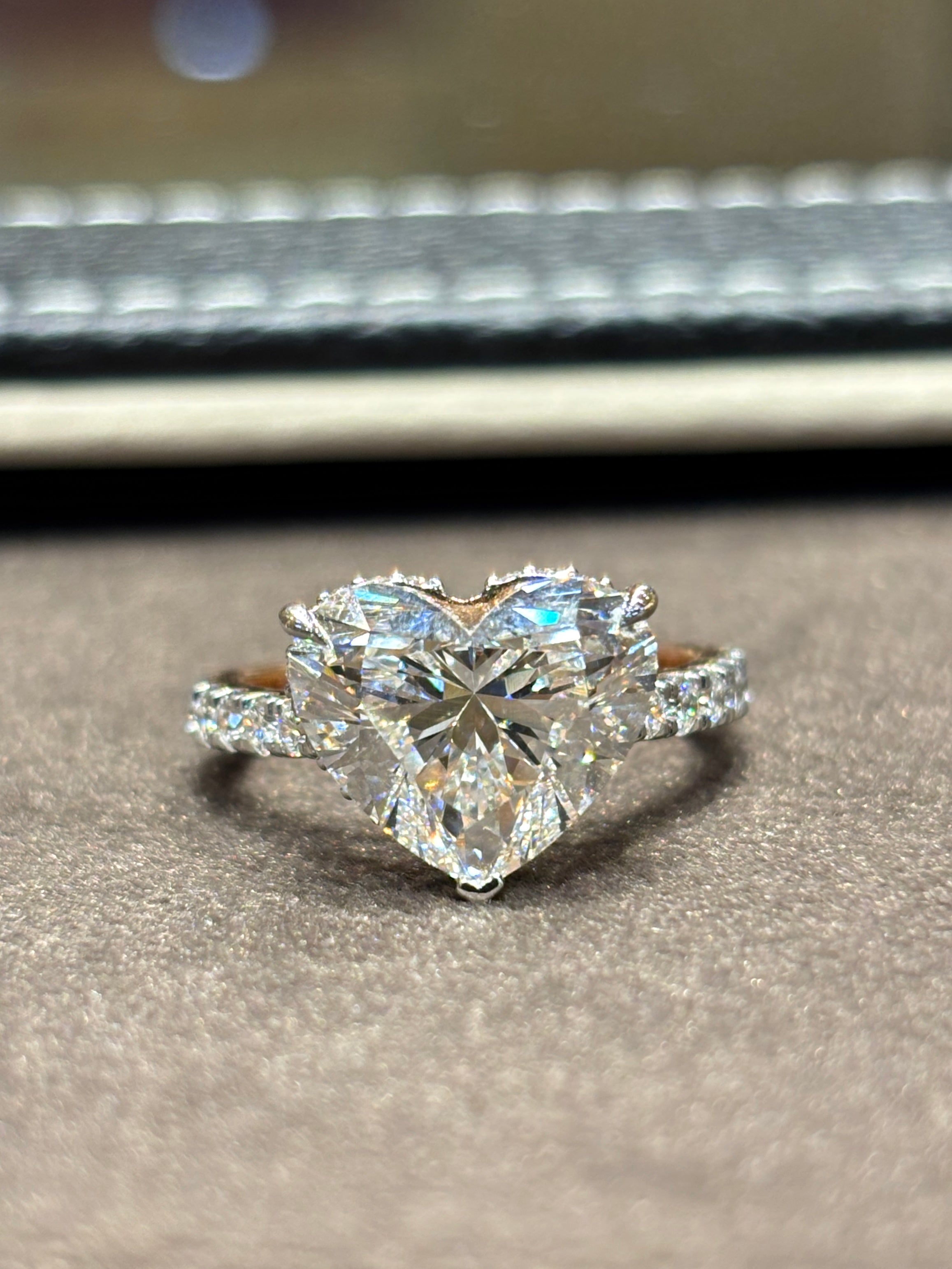 Close-up of Elandra 5ct Heart Lab Diamond Side Stone Solitaire Ring set in 18K Rose Gold by Fiona Diamonds