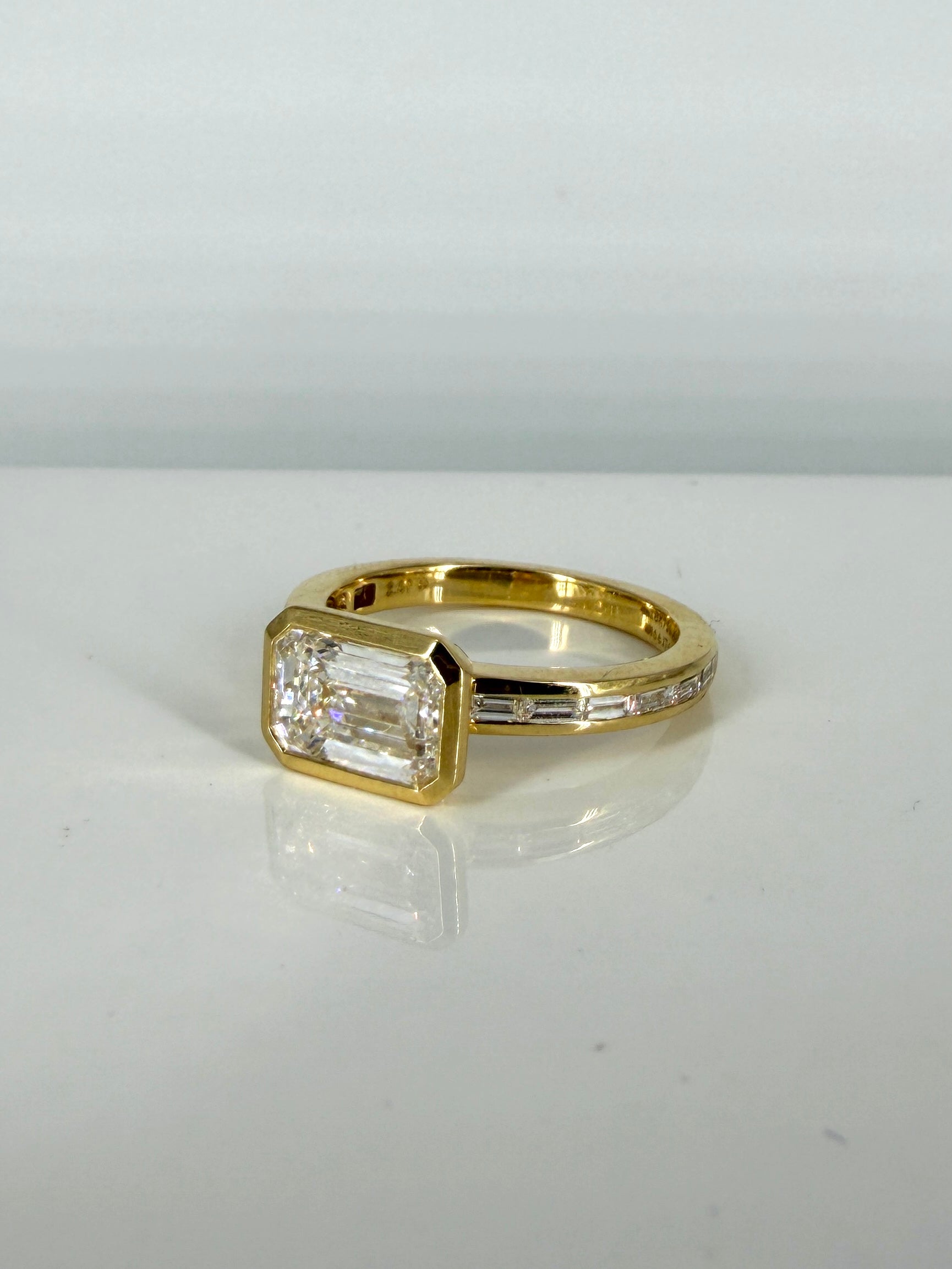 Top view of Blush Horizon 2ct Emerald Lab Diamond Side Stone Solitaire Ring in 18K Yellow Gold  Fiona Diamonds