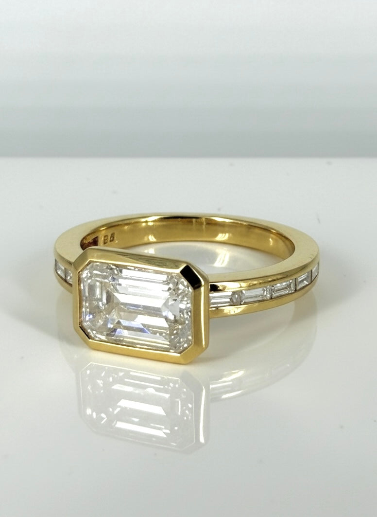 Close-up of Blush Horizon 2ct Emerald Lab Diamond Side Stone Solitaire Ring set in 18K Yellow Gold by Fiona Diamonds