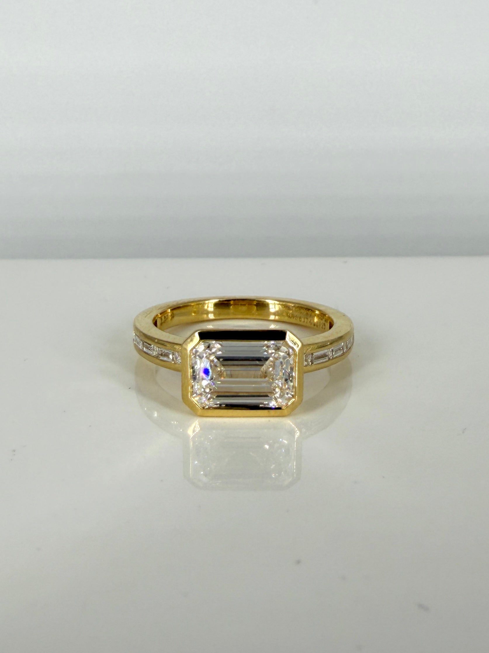 Fiona Diamonds Blush Horizon 2ct Emerald Lab Diamond Side Stone Solitaire Ring in 18K Yellow Gold on hand