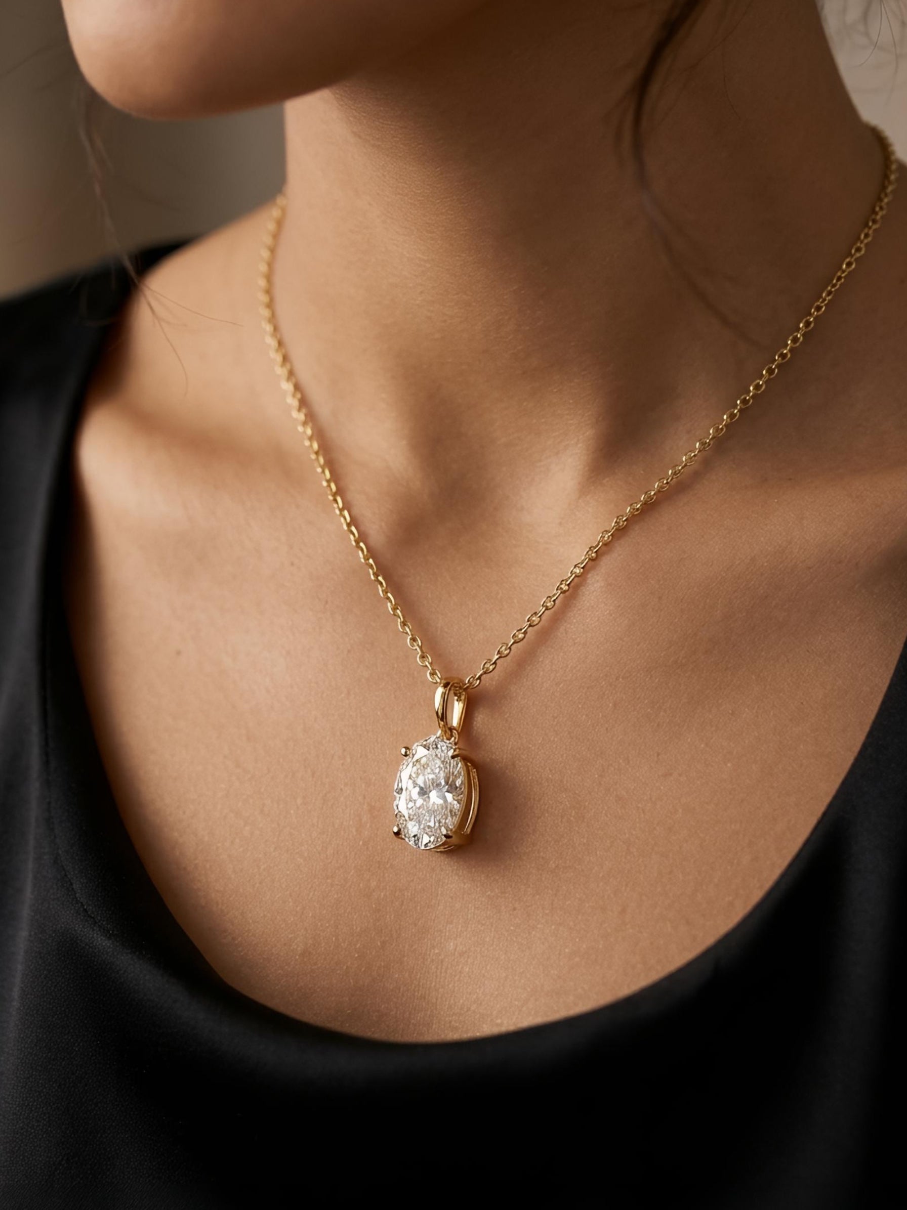 Side view of Raven Lore Oval Lab Diamond Solitaire Pendant in 18K Yellow Gold - Fiona Diamonds