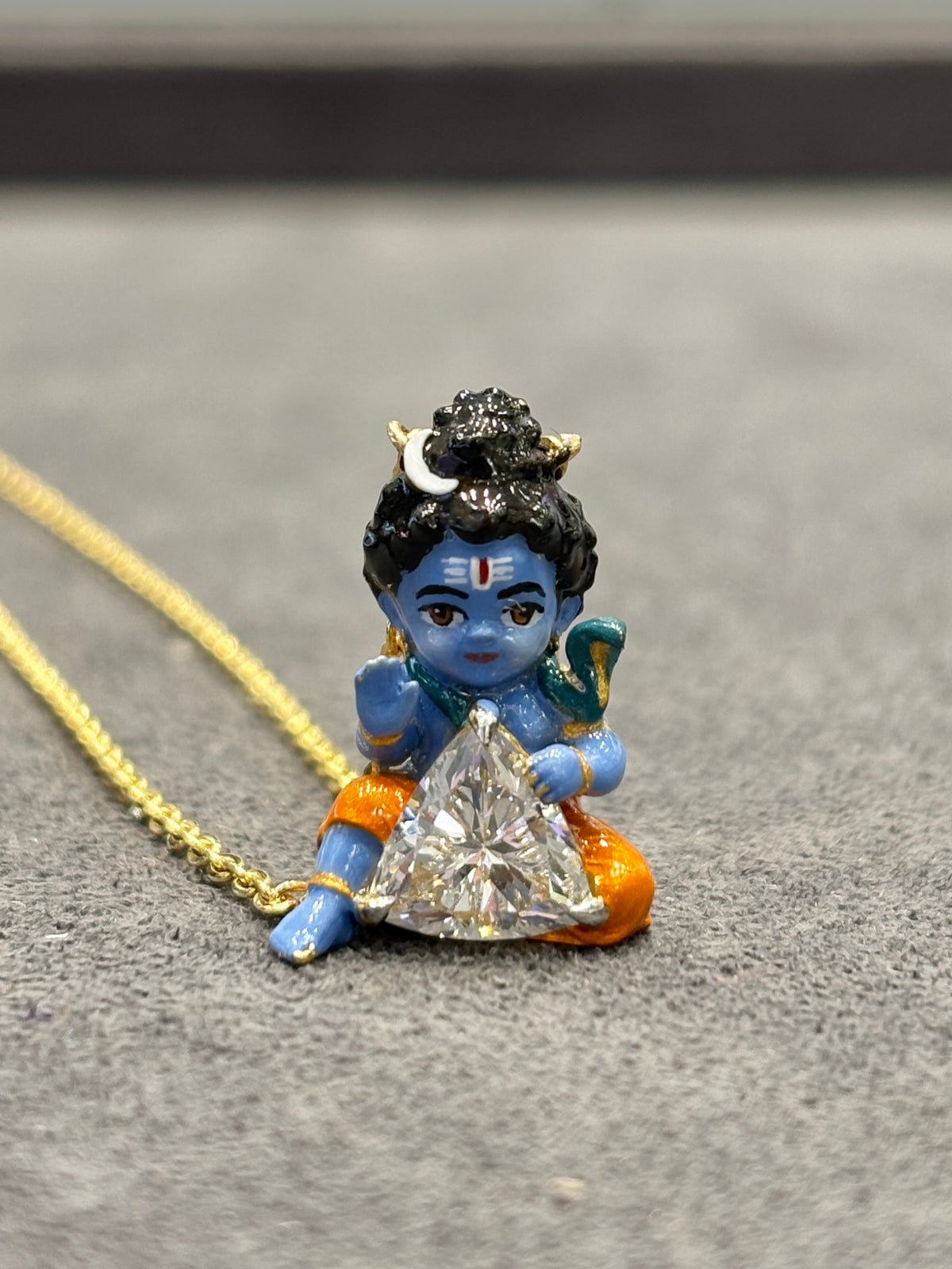 Asha Blessing Bal Shiva Trillion Lab Diamond Pendant – close-up on grey fabric showing enamel detail
