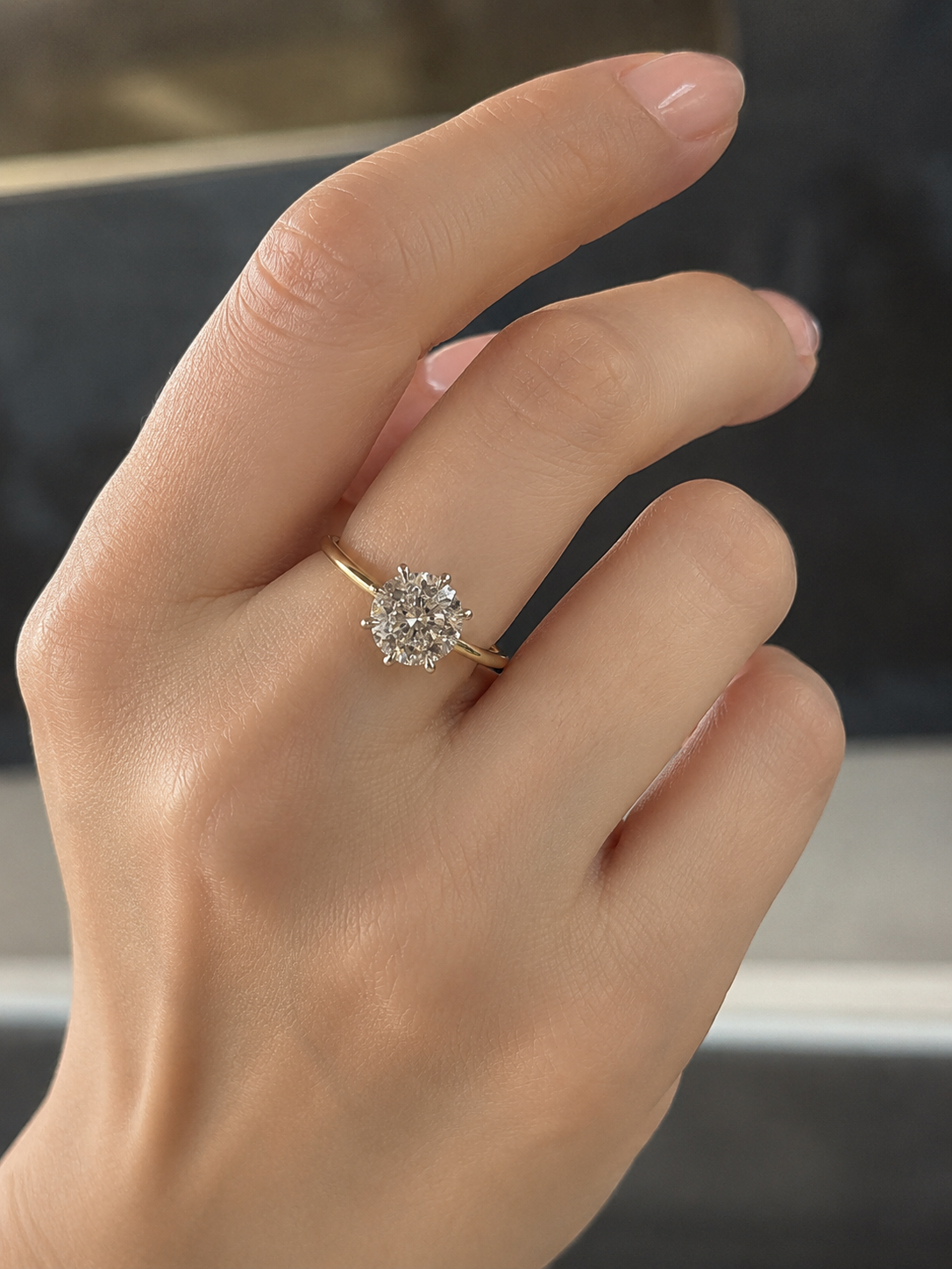 Side profile of Qaelith Crest Round Lab Diamond Classic Solitaire Ring in 18K Yellow Gold Fiona Diamonds