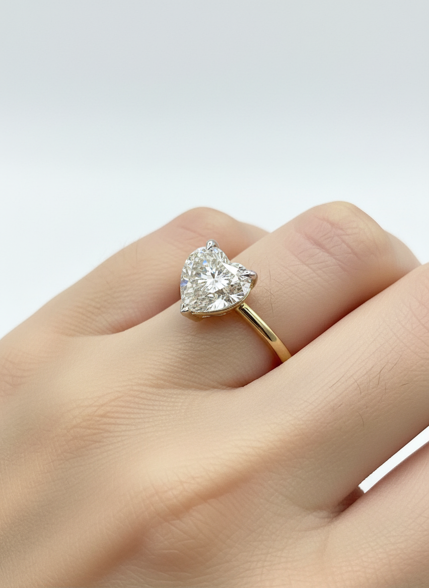 Close-up of Daelith Flare Heart Lab Diamond Classic Solitaire Ring set in 18K Yellow Gold by Fiona Diamonds