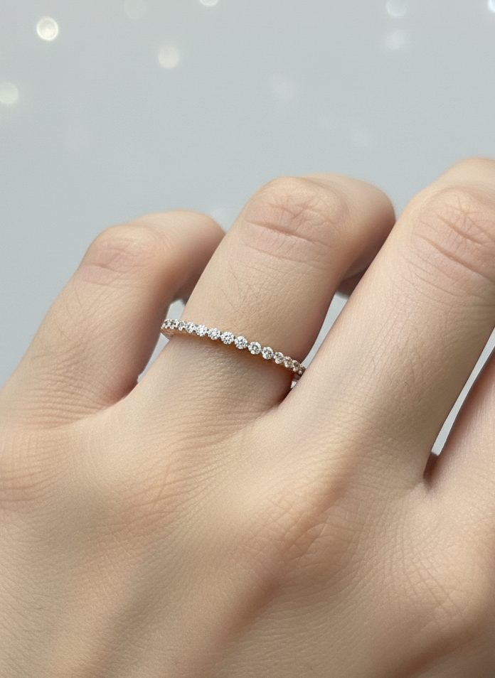 Close-up of Isariel Round Lab Diamond Eternity Ring set in 14K Rose Gold by Fiona Diamonds