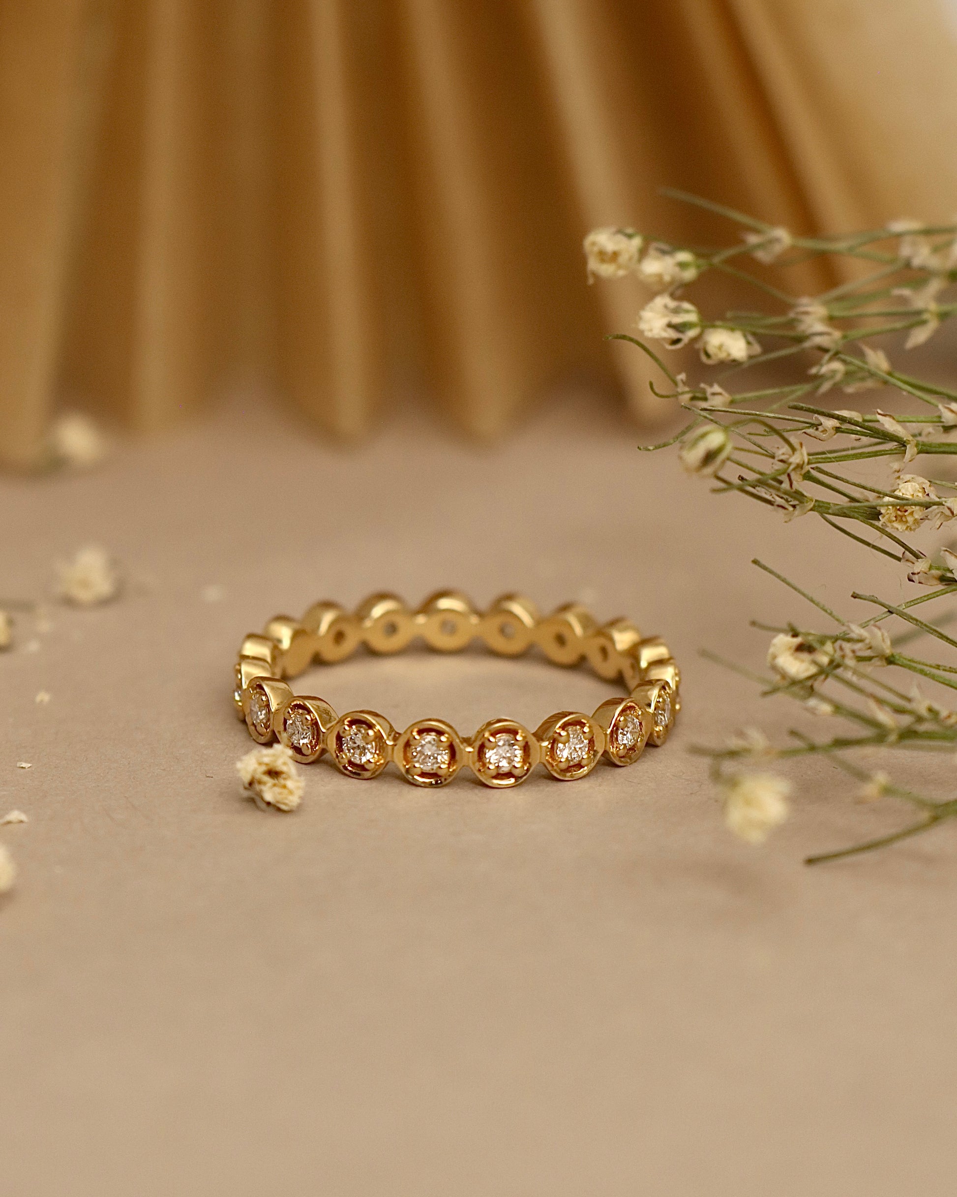 Close-up of Wanyi Round Lab Diamond Eternity Ring set in 18K Yellow Gold by Fiona Diamonds