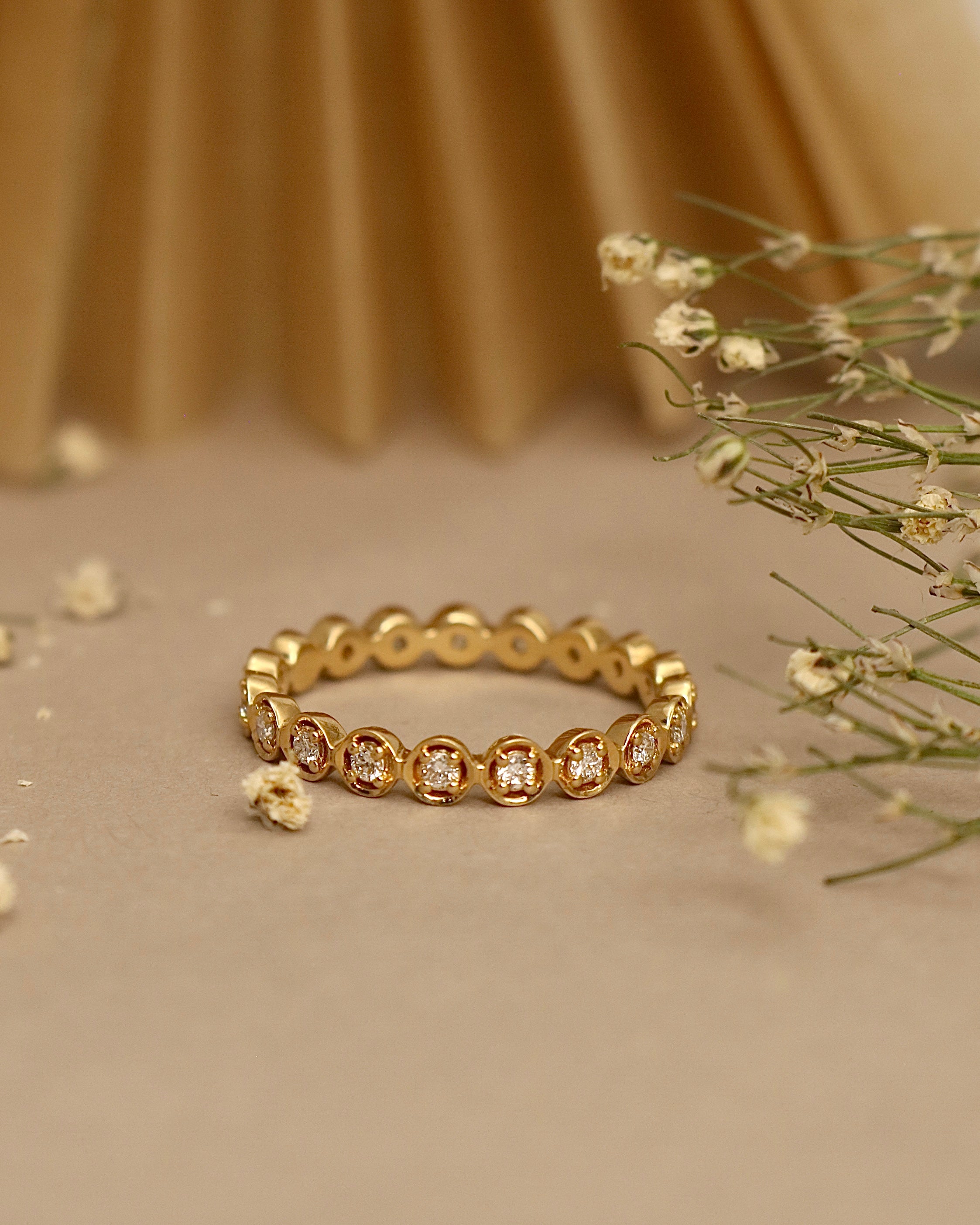 Close-up of Wanyi Round Lab Diamond Eternity Ring set in 18K Yellow Gold by Fiona Diamonds