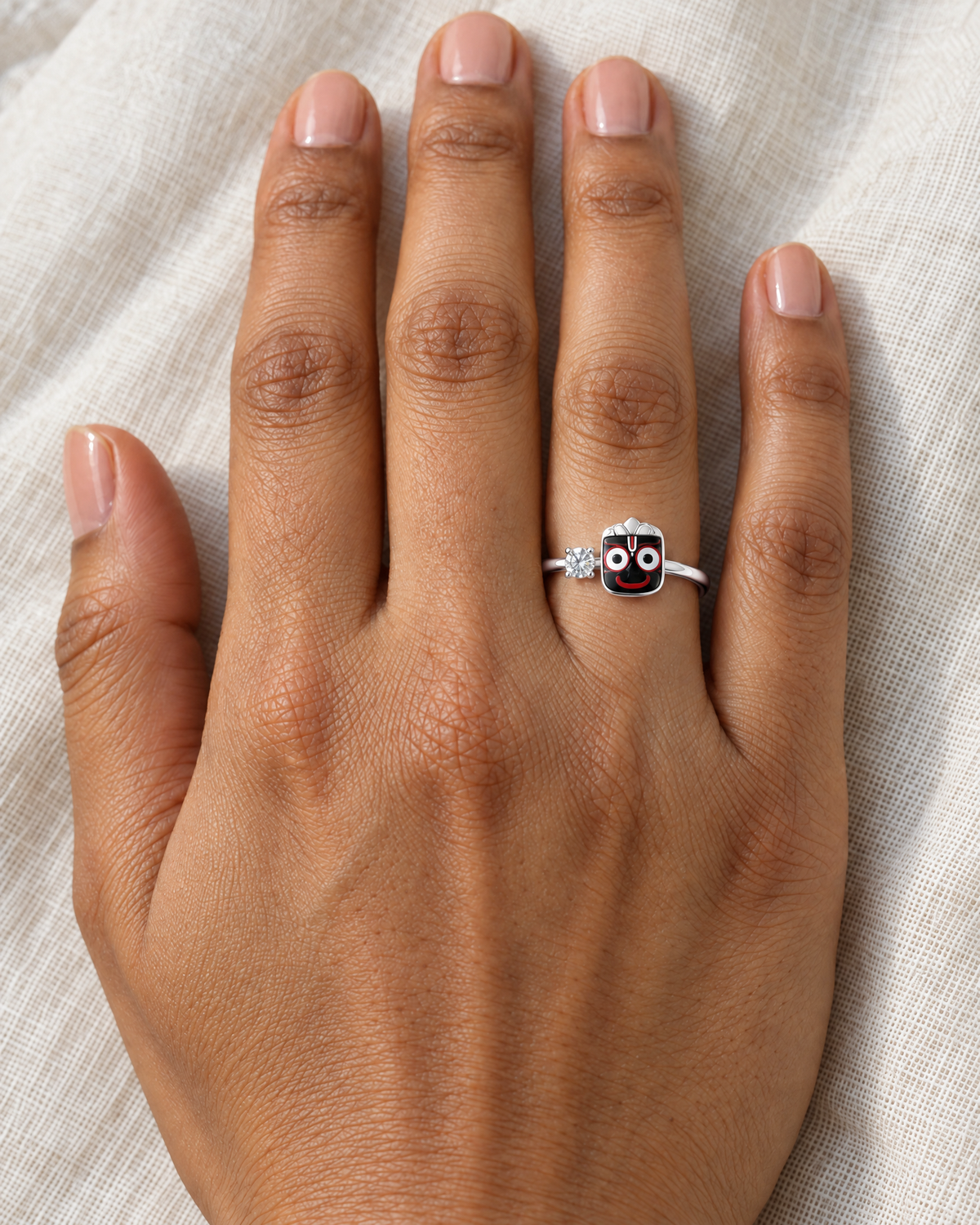 Jagannath Kalia ring in polished 925 sterling silver – black enamel Jagannath face with lab grown diamond solitaire, worn on the ring finger