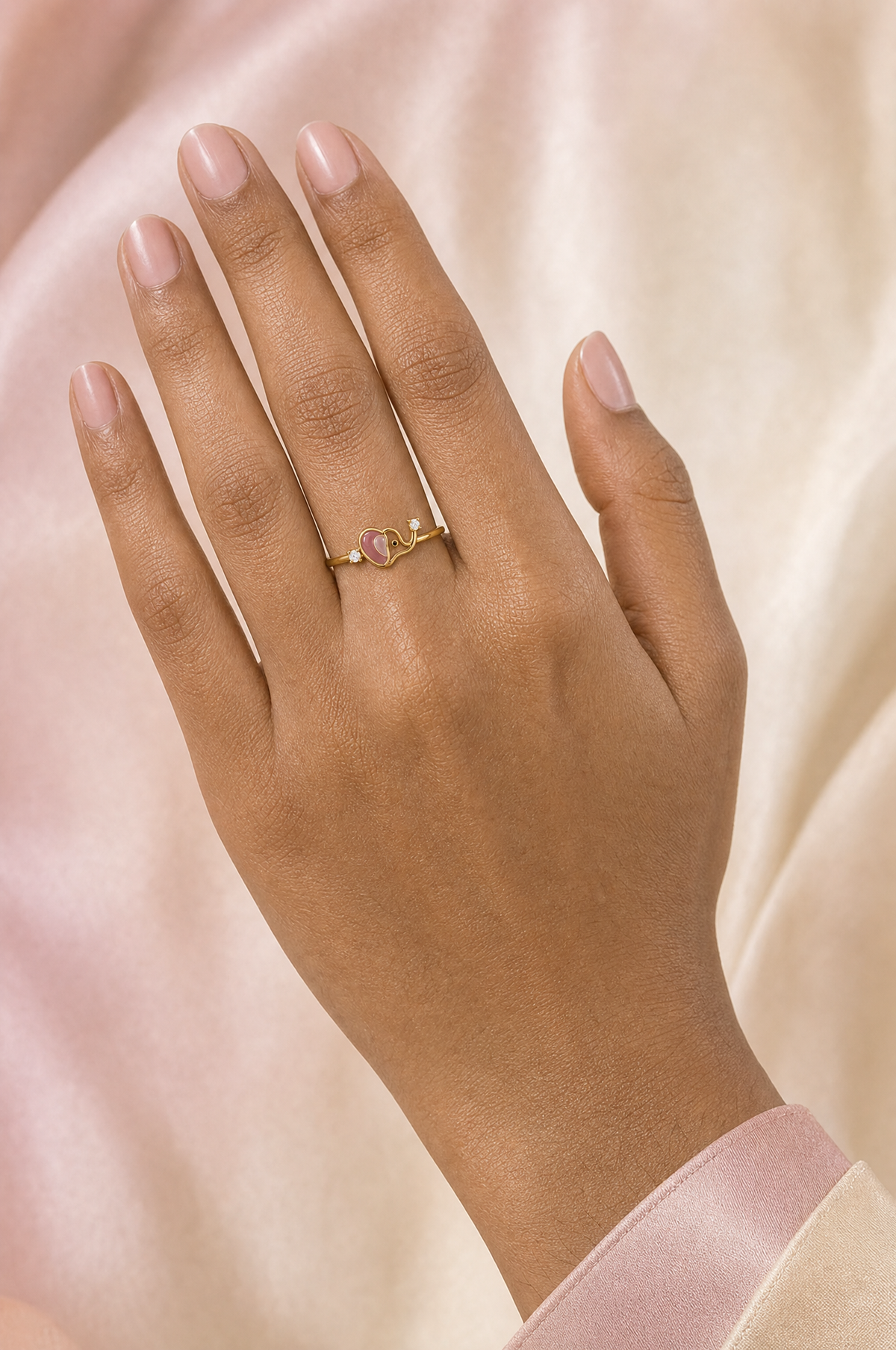 Amora Heart ring – pink heart-shaped enamel baby elephant with raised trunk holding a lab grown diamond, second diamond on the band, worn on the ring finger