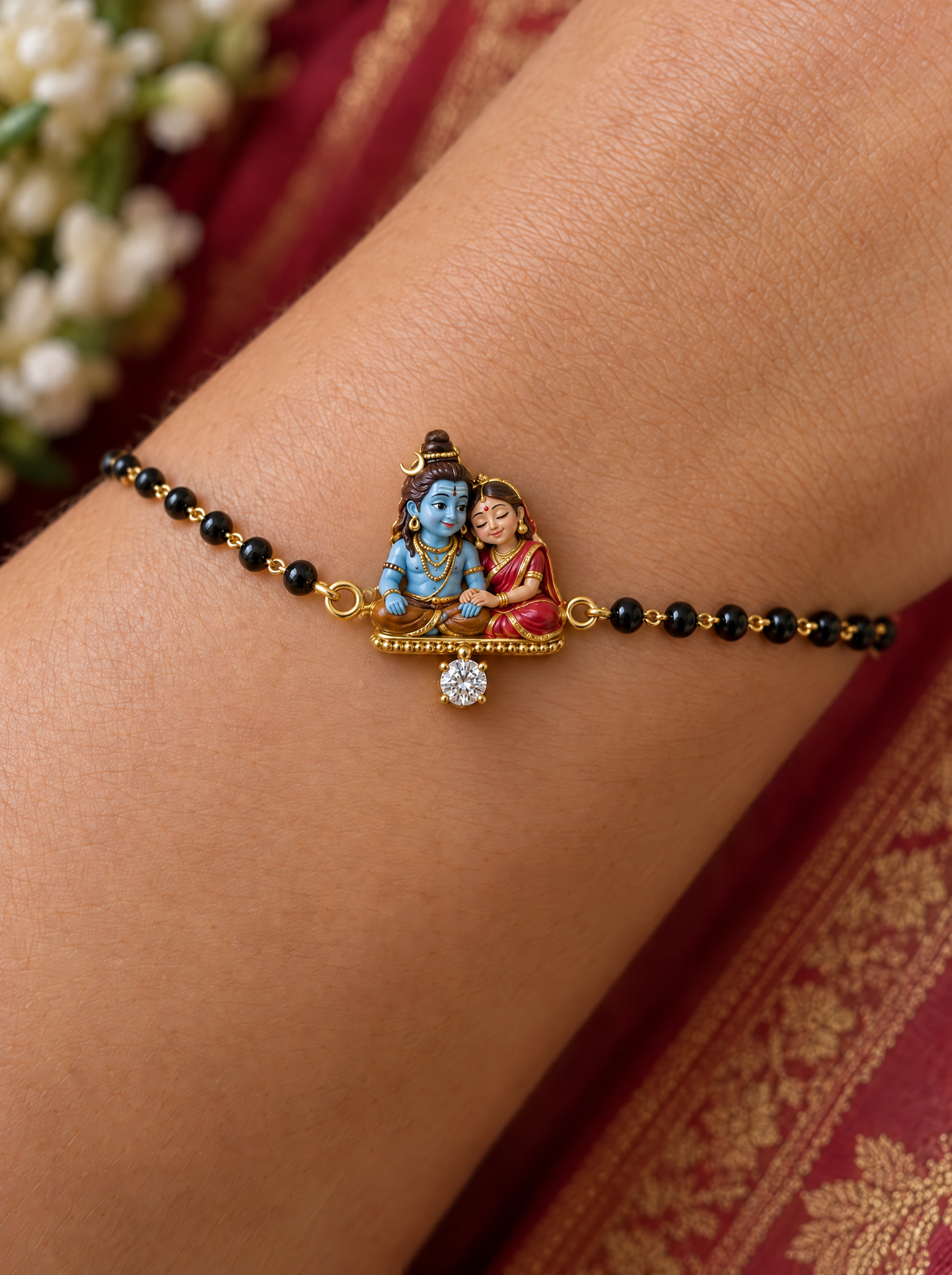 Sneh Shiv Gauri hand mangalsutra – enamel Gauri resting her head on baby Shiva's shoulder on a beaded gold base with a lab grown diamond, black bead chain on the wrist