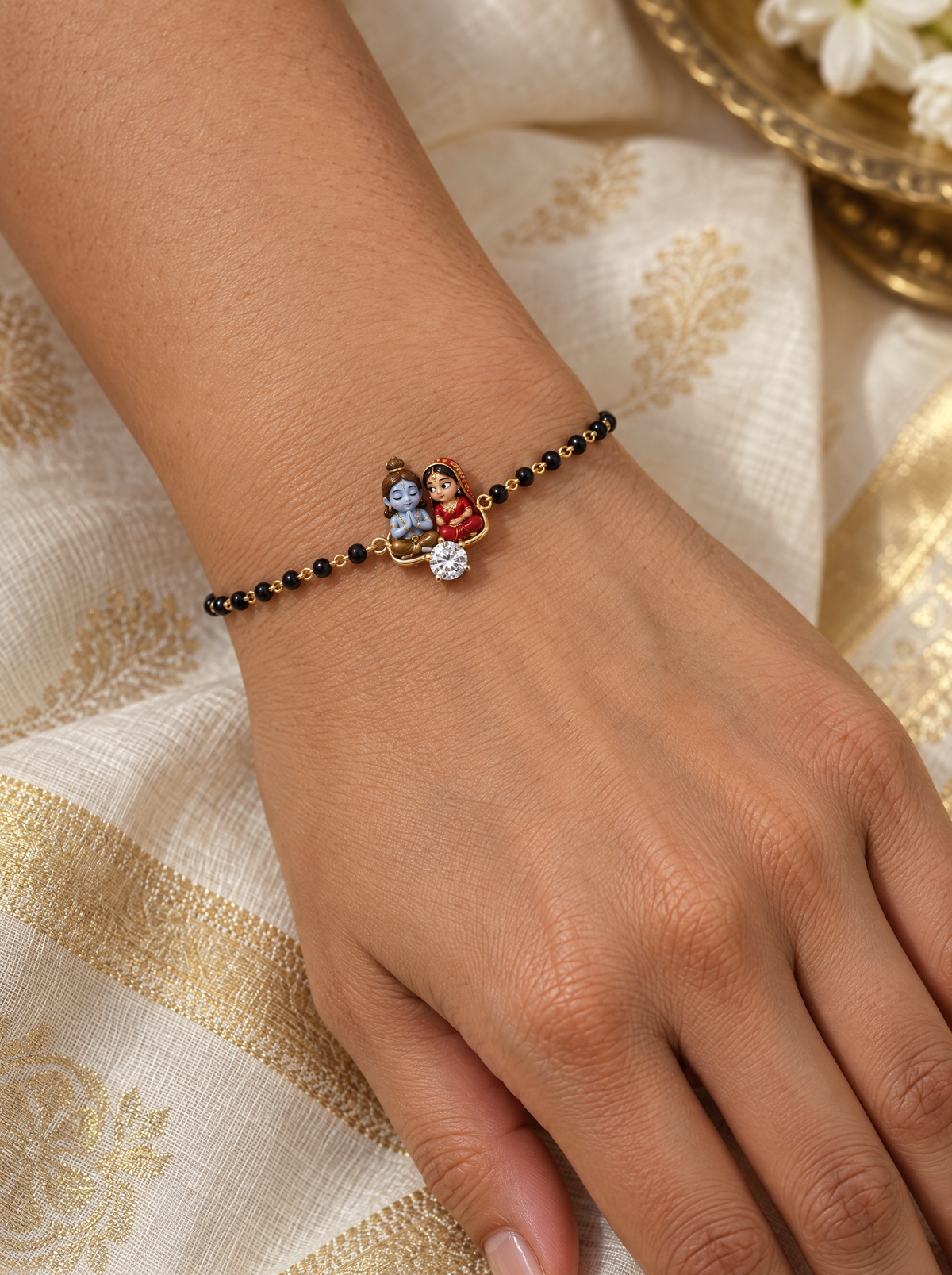 Sanidhya Shiv Gauri hand mangalsutra – enamel baby Shiva meditating beside Gauri in a heart-shaped gold frame with a lab grown diamond, black bead chain on the wrist