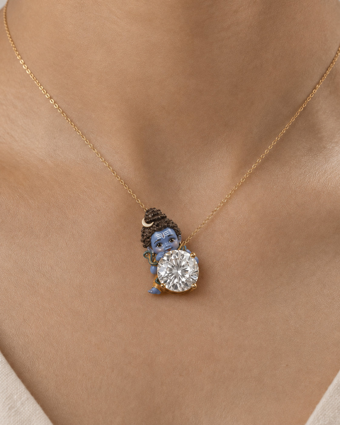 Chandrashekhar — enamel Bal Shiva watching over the diamond with the crescent moon in his jata, round lab-grown diamond pendant in yellow gold, Fiona Diamonds