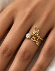 Krishna Venugopal ring – Krishna playing the flute under a peacock-feather crown, curved diamond-set flute and a lab grown diamond solitaire, worn on the ring finger