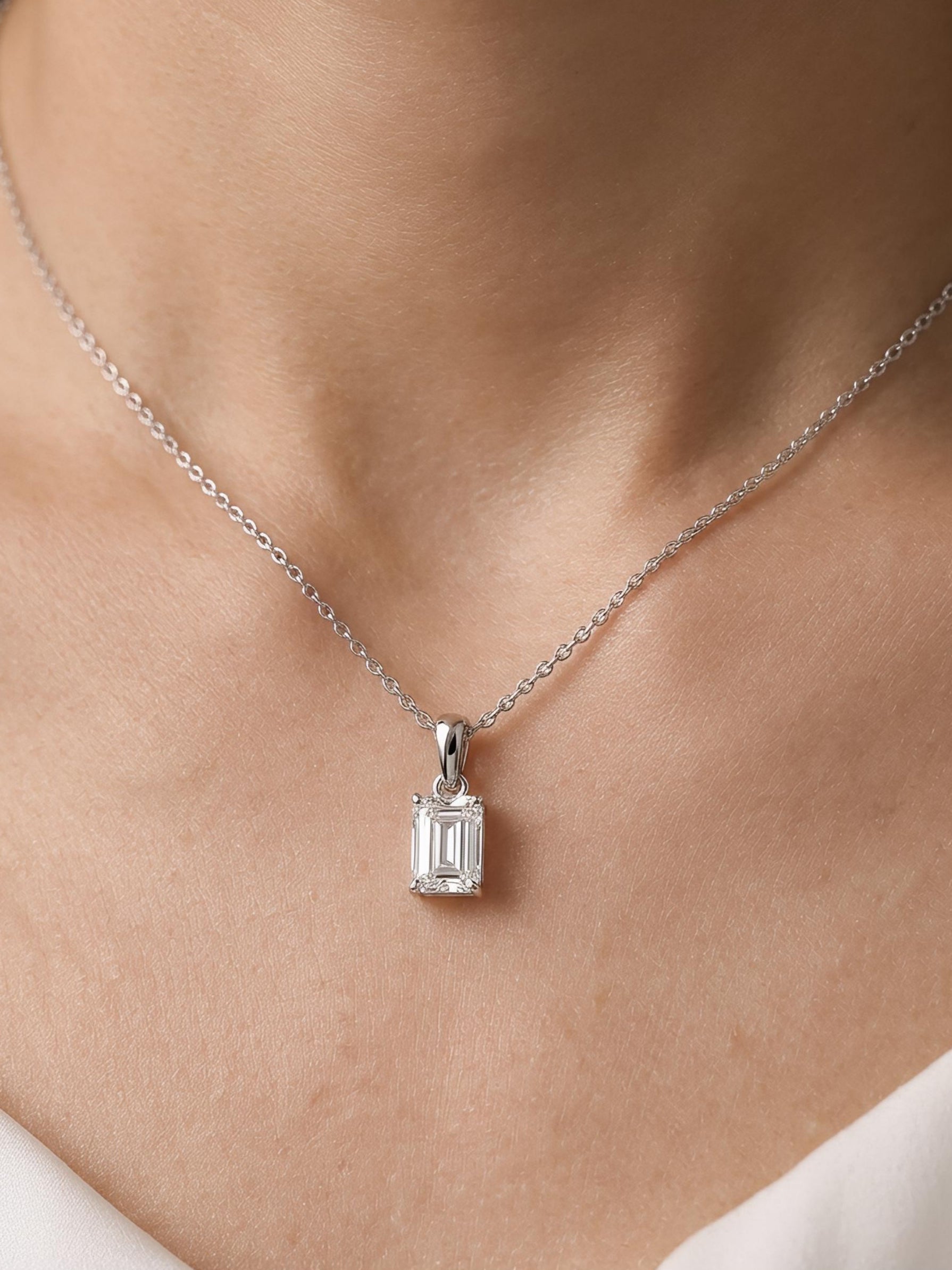 Side view of Fable Lore Emerald Lab Diamond Solitaire Pendant in 9K White Gold - Fiona Diamonds