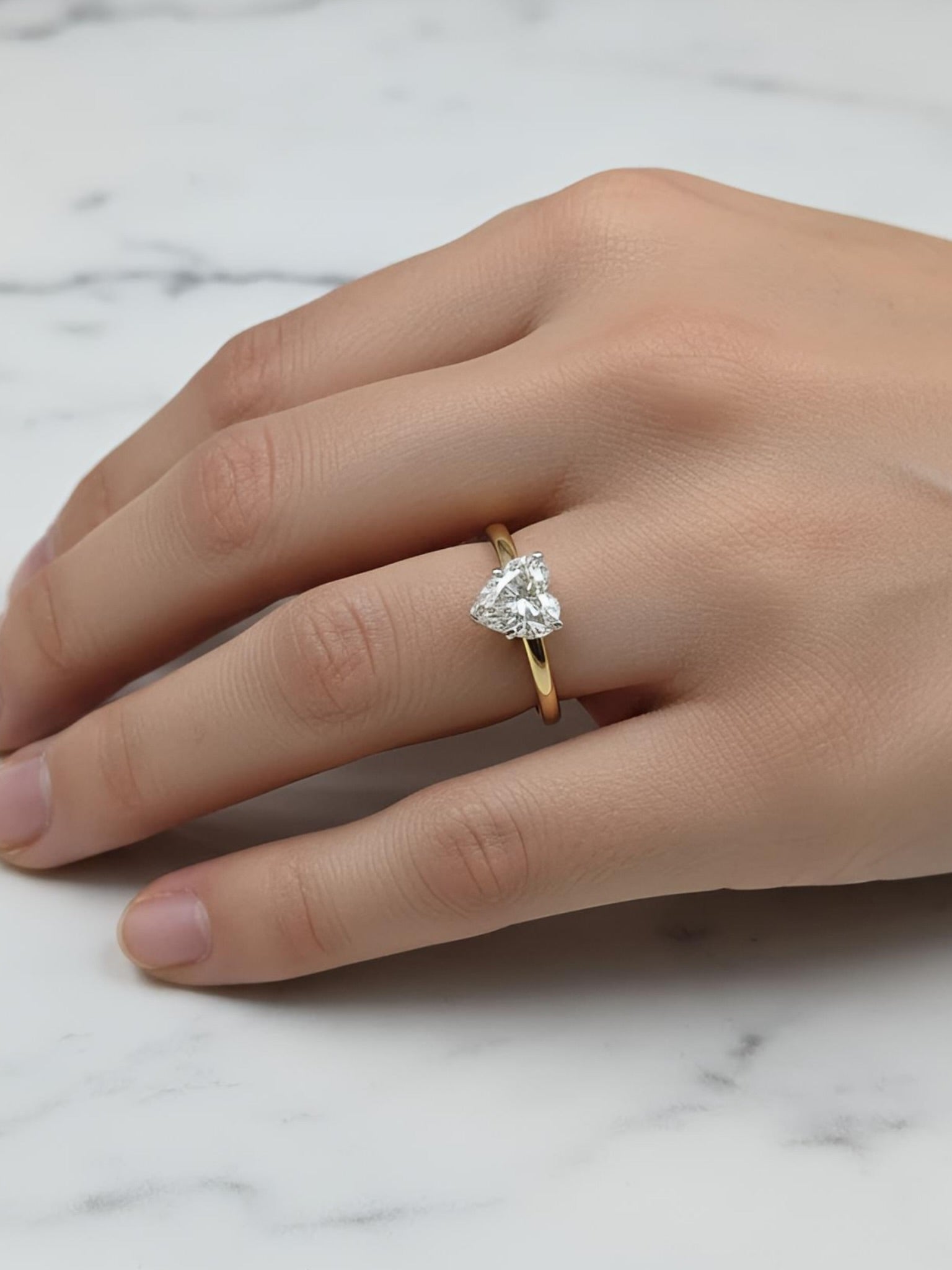 Close-up of 1ct Heart Aether Crest Heart Lab Diamond Classic Solitaire Ring set in 18K Yellow Gold by Fiona Diamonds
